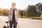 People, sports, leisure and active healthy lifestyle. Portrait of young hipster bicyclist wearing shirt standing near his bike whi