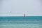 People sportsmen windsurfing and kite surfing in blue ocean water. Summer extreme exotic sport concept