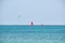 People sportsmen windsurfing and kite surfing in blue ocean water. Summer extreme exotic sport concept