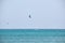 People sportsmen windsurfing and kite surfing in blue ocean water. Summer extreme exotic sport concept