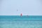 People sportsmen windsurfing and kite surfing in blue ocean water. Summer extreme exotic sport concept