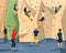 People in sportswear training on climbing wall