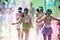 People are spotted during The Color Run street race and  having fun  Marathon, Bright color paint all over a large crowd.