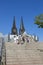 People on the stairs against the backdrop of the towers of the Cologne Cathedral