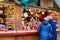 People at the stall on Christmas Market at Kaiser Wilhelm Memorial Church in Winter Berlin, Germany. Advent Fair Decoration and