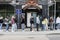 people stand in line next to the sign of the Main office for Migration issues