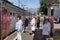 People stand on the platform at the time of covid-19 in front of the electric train