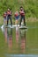 people on stand up paddle board paddeling