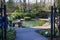 People standing around a silky green pool in the garden surrounded by lush green trees and plants at Atlanta Botanical Garden