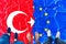 People standing on Turkey and Eu cracked flag