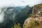 People on steep rocky cliff at Fortaleza Canyon