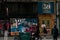 People on the street passing by the colorful doors of 59 Rivoli, art gallery in Paris, France.