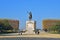 People strolling along grand statue of Louis XIV on horseback with ornament plant at Promenade du Peyrou in Montpellier, France