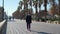 People strolling along pedestrian seafront walkway of Valencia. Spain