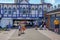 People strolling along the promenade which runs underneath the Pier. Shot taken on a bright blue sky summer`s afternoon and