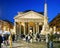 People strolling in front of the Pantheon in Piazza della Rotonda in Rome on an autumn evening