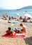 People sunbathing and swimming at Budva Beach