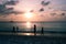 People at sunset on Palm Beach, Aruba
