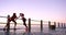 People, sunset or runners at beach stretching for running, exercise or fitness workout in promenade. Friends, wellness