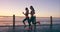 People, sunset or runners at beach for training, exercise or fitness workout with women in promenade. Ocean, friends or