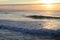 People surfing huge waves in colorful sunset in atlantic ocean, capbreton, france