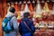 People at Sweet stall of cookies and candies on Christmas Market at Alexanderplatz in Winter Berlin, Germany. Advent Fair