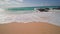 People swim in the ocean. Yellow sand at Sandy Beach on the tropical island of Oahu Hawaii. The turquoise color of the