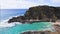 People swim in the turquoise waters of the Tropical Beach. Halona Beach Cove. Blue Waves of the Pacific Ocean Beats Oahu