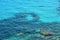 People swimm and snorkeling inside paradise clear torquoise blue water in Favignana island, Bue Marino Beach, Sicily Sout