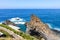 People swimming in natural swimming pools in the Atlantic ocean in Seixal, Madeira island, Portugal. Surrounded by volcanic rocks