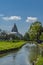 People swimming at the river, background Tissamaharama Raja Maha Vihara Buddhist stupa, vertical