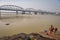 People take bath at the river Ganges near Bally bridge.