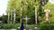 People taking picture in front of native totem poles inside Stanley Park