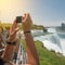 People taking pictures during the tourist tour to Niagara Falls at sunny summer day