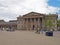 people and taxis in saint georges square huddersfield in front of the facade of the historic victorian train station