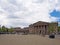 people and taxis in saint georges square huddersfield in front of the facade of the historic victorian train station