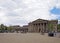 people and taxis in saint georges square huddersfield in front of the facade of the historic victorian train station