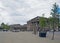 people and taxis in saint georges square huddersfield in front of the facade of the historic victorian train station