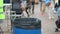 People throwing litter in waste bin, environmental pollution, global consumerism