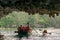 People in tour boat and kayaks exploring caves in Ha Long bay in Vietnam