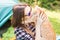 People, tourism and nature concept - Woman in sunglasses holding a cat sitting near the tent