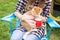 People, tourism and nature concept - Woman in sunglasses stroking a cat sitting near the tent