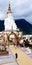 People or tourist come to worship big white Buddha statue and the sacred things at Wat Pha Sorn Kaew