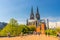 People tourists walking down pedestrian street square near Ludwig Museum with view of Cathedral in Cologne