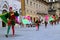 People in traditional costumes with flags and drums are going on Piazza del Campo in Contrada Day.