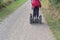 People traveling in countryside on two-wheeled, self-balancing personal transporter