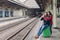 People, travelling, relationship concept. Happy unshaven husband and wife embrace at railway station, going to have trip, have