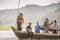 People travelling in rural Banglkadesh in a dugout boat