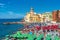 People under umbrellas on public beach of Camogli in Liguria, Italy.