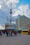 People at Urania World Clock with Television tower Alexanderplatz Berlin